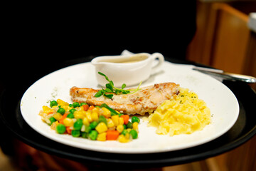 Chicken breast served with massed potato, vegetables and mushroom sauce