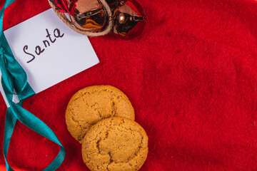 note to Santa on a red background with bells and cookies, Christmas concept