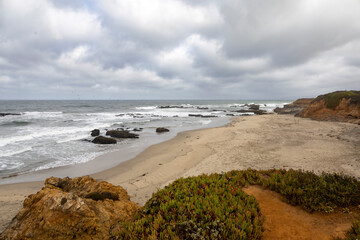A view of the rugged beauty of Pescadero State Beach on the Pacific Coast of California, featuring captivating ocean views, rocky shores, and serene sandy stretches.