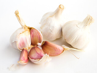 Garlic heads and cloves on white background