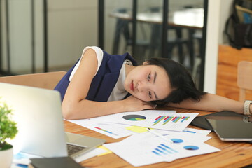 Asian woman stressed out working in the office