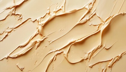 Naklejka premium Artistic texture of creamy beige paint applied on a canvas in soft strokes