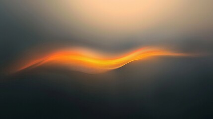 A smooth gradient transitions from deep gray to warm hues of orange, yellow, and brown, creating a soft blend in the center against a dark gray backdrop.