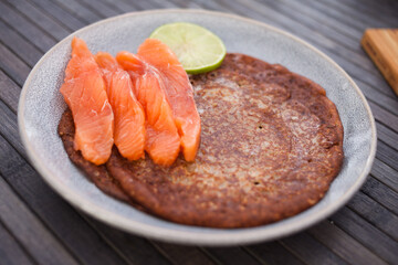 Salted salmon fillet with rye pancakes and lime