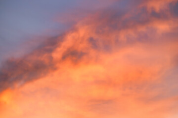 A beautiful sky tinted by the sun leaving vibrant shades of gold, pink, blue and multicolored. Clouds in the twilight evening and morning sky. Cloudy sky background in the evening, and during the day.