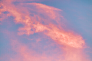 Obraz premium A beautiful sky tinted by the sun leaving vibrant shades of gold, pink, blue and multicolored. Clouds in the twilight evening and morning sky. Cloudy sky background in the evening, and during the day.