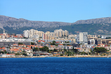 Fototapeta premium Contemporary buildings, gardens and beaches at the waterfront in Split, Croatia. View of Split from the boat.