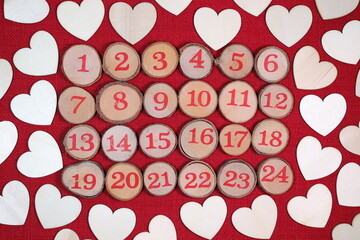 Wooden Christmas Advent, 1 to 24 Christmas countdown, surrounded by wood love hearts, against a red stitch background. 