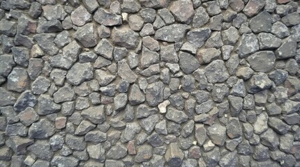 Fototapeta premium The rugged surface of rough stone is a testament to nature's artistry, showcasing uneven edges and varied grain patterns.