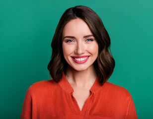 Obraz premium Portrait of Beautiful Young Woman Happily Smiling Against Studio Background