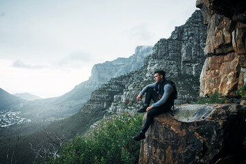 Hiking, thinking and peace with man on mountain for explore, travel and adventure. Challenge, wellness and holiday with person and trekking in nature for backpacking, relax and camping vacation