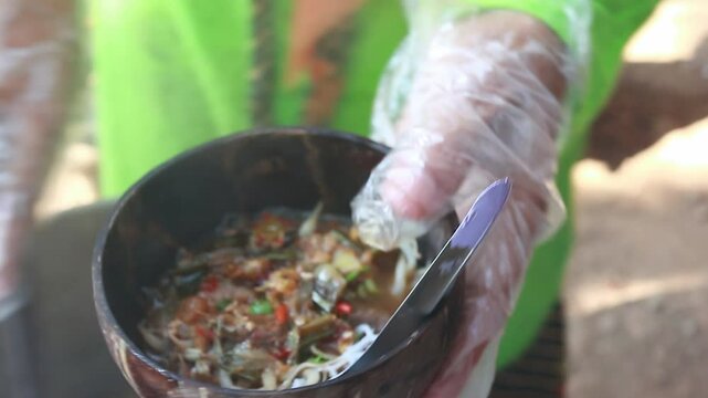 brewing soto soup in a coconut shell bowl