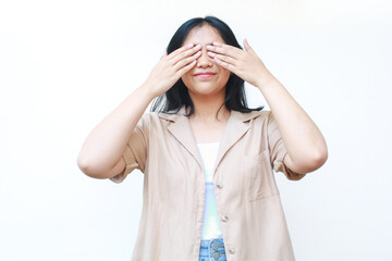 happy asian woman covering her eyes with hand wearing casual brown clothes isolated on white background