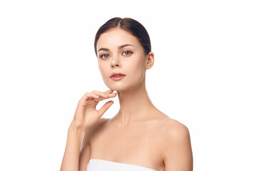 Woman posing with hand on chin, looking at camera, isolated on white background