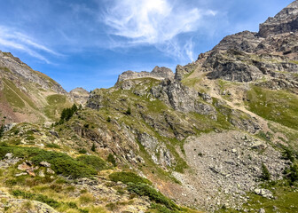 breathtaking mountain landscape scree dark rock vegetation sky