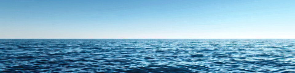 Obraz premium A calm blue sea, its surface dotted with small whitecaps under a clear sky.