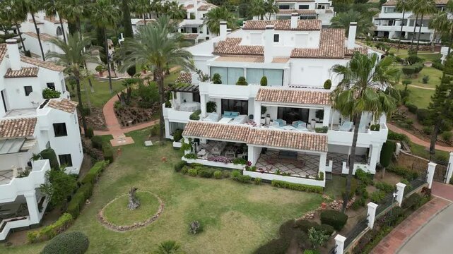 luxury villa properties real estate in marbella spain downward aerial flying towards a building apartment
