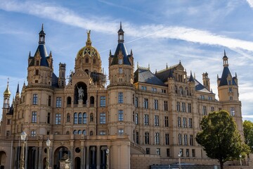 Fototapeta premium Picturesquely located on an island in Lake Schwerin, Schwerin Castle with its numerous towers is a fairytale castle that you couldn't imagine being more beautiful
