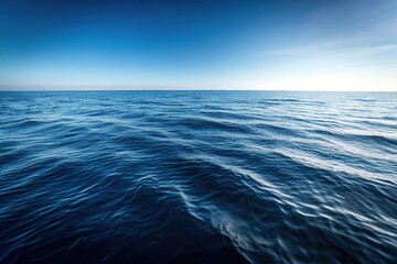Obraz premium A black and white image of the ocean surface with a long shot perspective