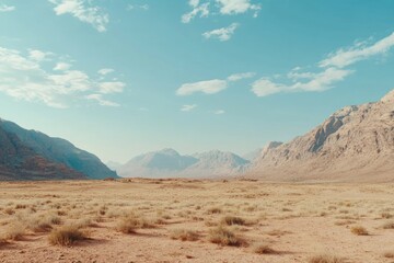 Naklejka premium Vast Desert Landscape with Mountains and Blue Sky