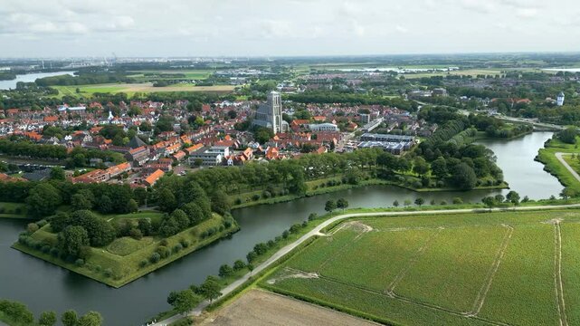 moving towards historic 17th century church fortified town brielle netherlands revealing intricate fortifications surrounding forward aerial shot view motion dutch history 