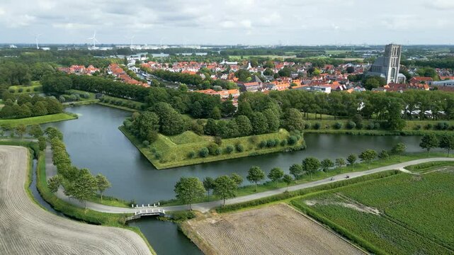 historic fortified town brielle 17th century church distant views traditional dutch windmills surrounding fortifications circling aerial view netherlands history scenic panoramic shot 