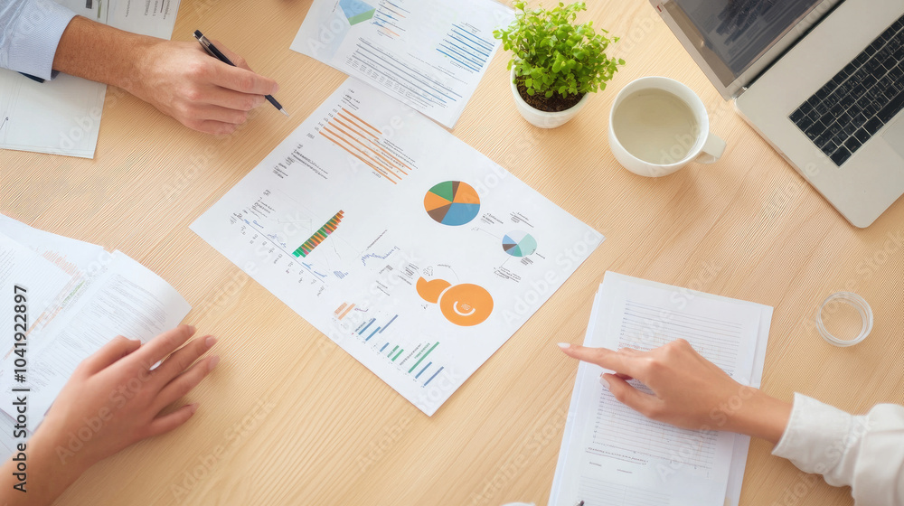 Poster business meeting dynamics, hands engaged in discussion, analyzing charts and graphs, documents sprea