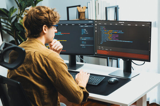 Working IT developer with stressful overworked in creating online software development coding on pc screen, thinking program for latest version application on website project at modern office. Gusher.