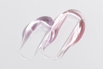 Cosmetic gel or beauty jelly serum texture background. Pink transparent skin care collagen product