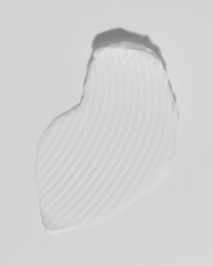White beauty cream smear smudge on white background. Cosmetic skincare product texture. Face cream, body lotion swipe swatch
