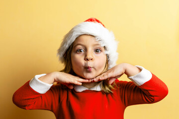 Close up portrait of girl with funny gesture, dressed as Santa Claus