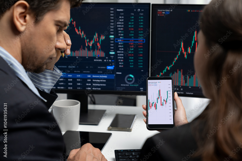 Aufkleber focusing on phone with discussing dynamic stock market in two business traders online website compar