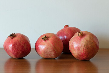 Pomegranates as a delicious autumn fruit isolated on white background