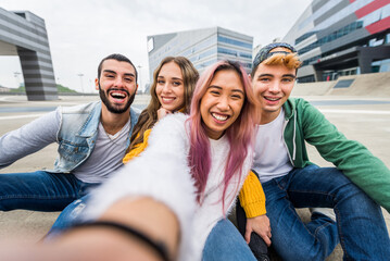 Multiethnic group of young students bonding outdoors - Happy teen students  meeting outside school...