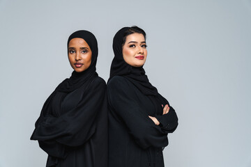 Beautiful arab middle-eastern women with traditional abaya in studio