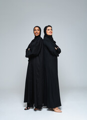 Beautiful arab middle-eastern women with traditional abaya in studio