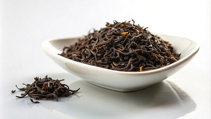 Fototapeta premium Forced perspective tea sample in white dish with black tea leaves on white background