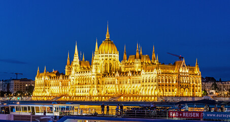 Hungarian Parliament at Night Along Danube River in Pest in Budapest, Hungary.