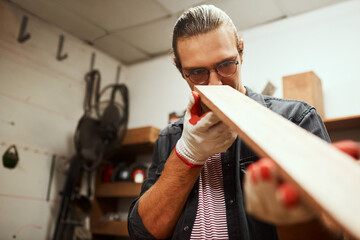 Man, carpenter or checking with wood at workshop for project or woodwork at manufacture. Precision,...