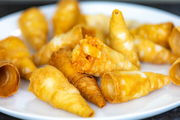 Traditional savory straws stuffed with chicken and hearts of palm