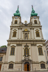 Fototapeta premium Baroque Twin Clock Towered Saint Anna Church in Buda Along Danube River in Budapest, Hungary.