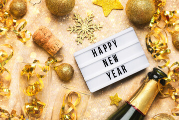 Happy new year 2025.Top view of lightbox with the word Happy new year 2025,crystal glasses and...