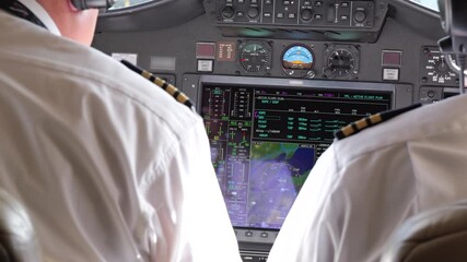 inside cockpit private jet pilots they navigate using advanced instruments navigation systems panning shot view aviation video perspective flying aircraft technology operations overview 