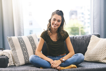 Happy, morning and portrait of woman on sofa for resting, relaxing and comfortable on weekend. Home, living room and person on couch for chilling, break and calm with confidence, pride and smile