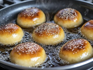 A close-up of sufganiyot frying in a pan, perfectly golden and sizzling, with bubbles emerging from the oil, showcasing the dough's texture, on a kitchen stove.