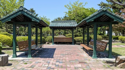 Obraz premium A tranquil park setting featuring a beautifully crafted architectural pavilion surrounded by lush greenery and comfortable wooden benches