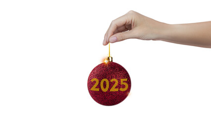 A woman's hand holds a red shiny Christmas tree ball with the inscription 2025 isolated on white...