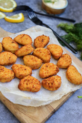 Crispy  deep fried   chicken  popcorn  nuggets and french fries . Breaded  with Cornflakes chicken  Breast fillets  with chilly peppers and fresh   basil on wooden rustic background