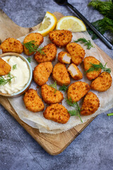 Crispy  deep fried   chicken  popcorn  nuggets and french fries . Breaded  with Cornflakes chicken  Breast fillets  with chilly peppers and fresh   basil on wooden rustic background