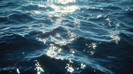 Obraz premium Deep blue sea water with a slightly rough surface, reflecting sunlight on a clear day.